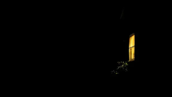 Light on a window during a very dark night