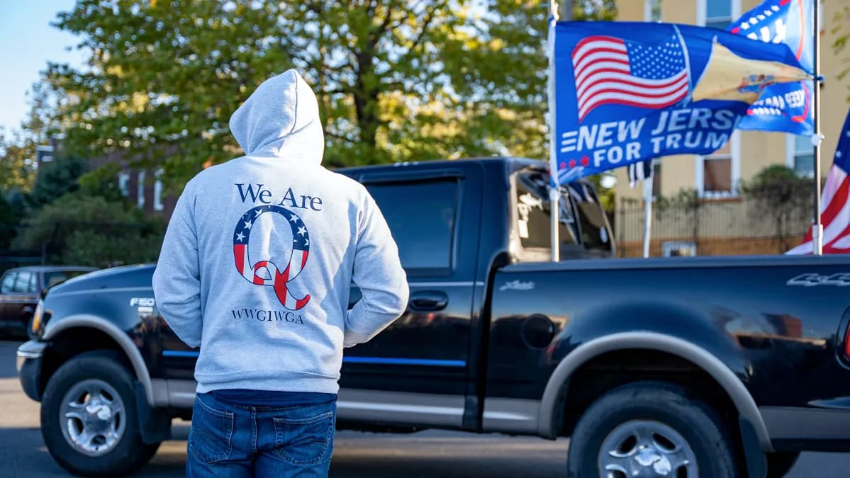 Back of a person wearing a "We are Q" hoodie