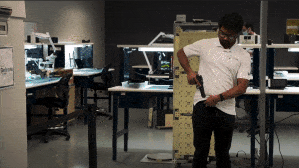 Man with gun walking by detector