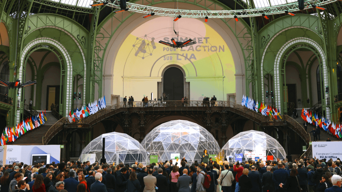 AI Action Summit in a grand hall with domes, flags, and a crowd attending the event.